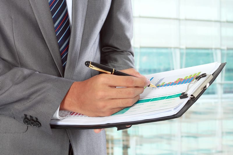 Business person holding checklist